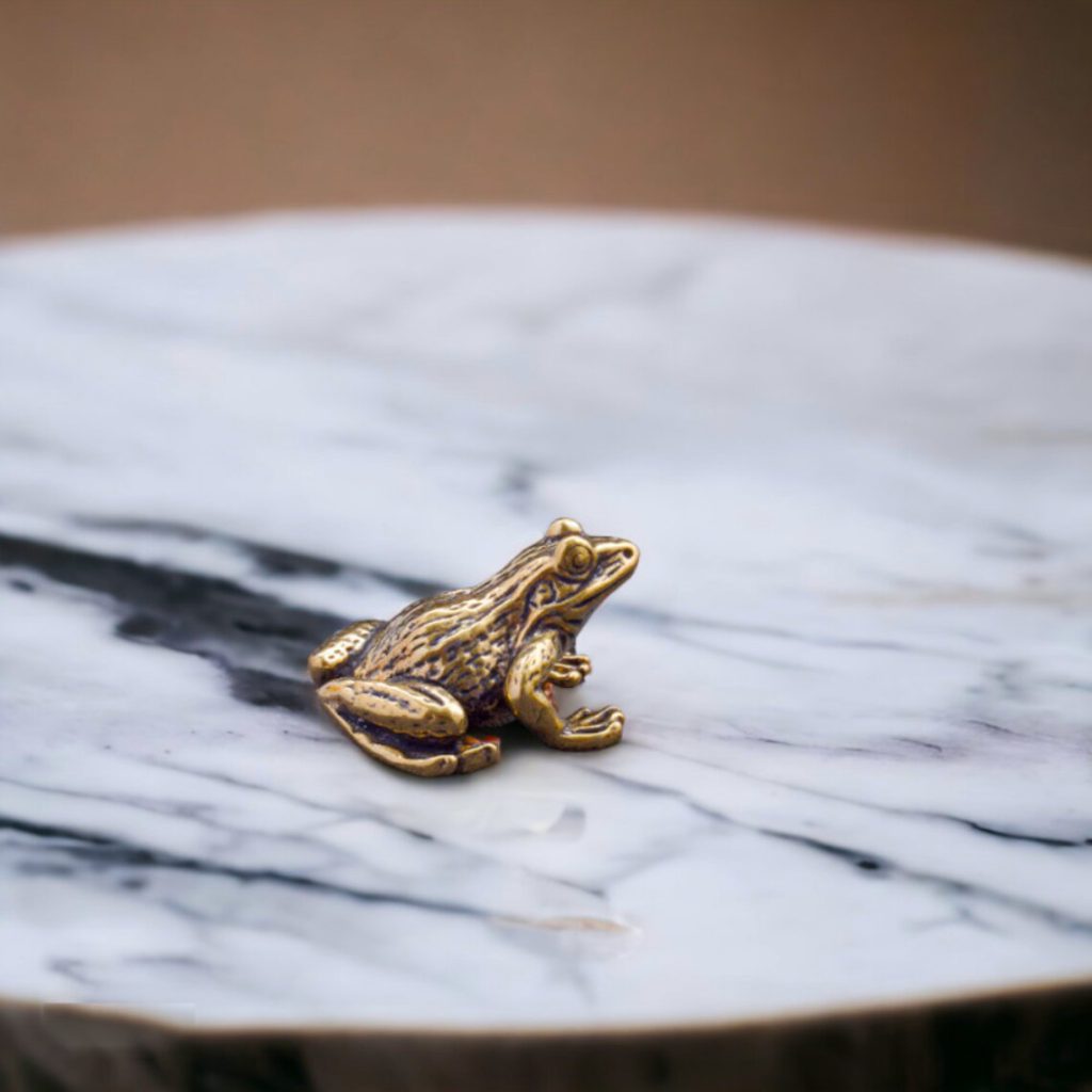 A gilded frog in a world of marble